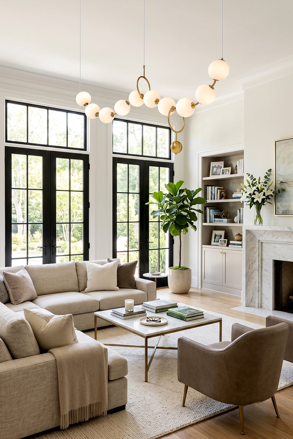 Delphine Pearl Strand Chandelier illuminating a stylish living room with modern decor and natural light.