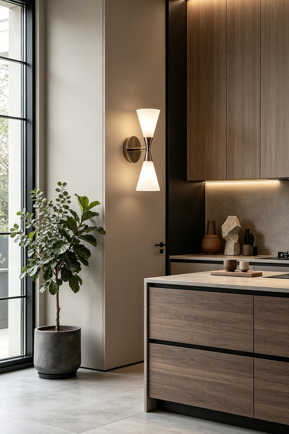 Diabolo Symmetry Glass Wall Sconce illuminating a modern kitchen with wood and marble elements.
