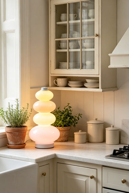 Dolce Stacked Pastel Glass Table Lamp | Glass, Metal | Placed on a classic white kitchen counter next to terracotta herb pots and traditional cabinetry | vexa lamps