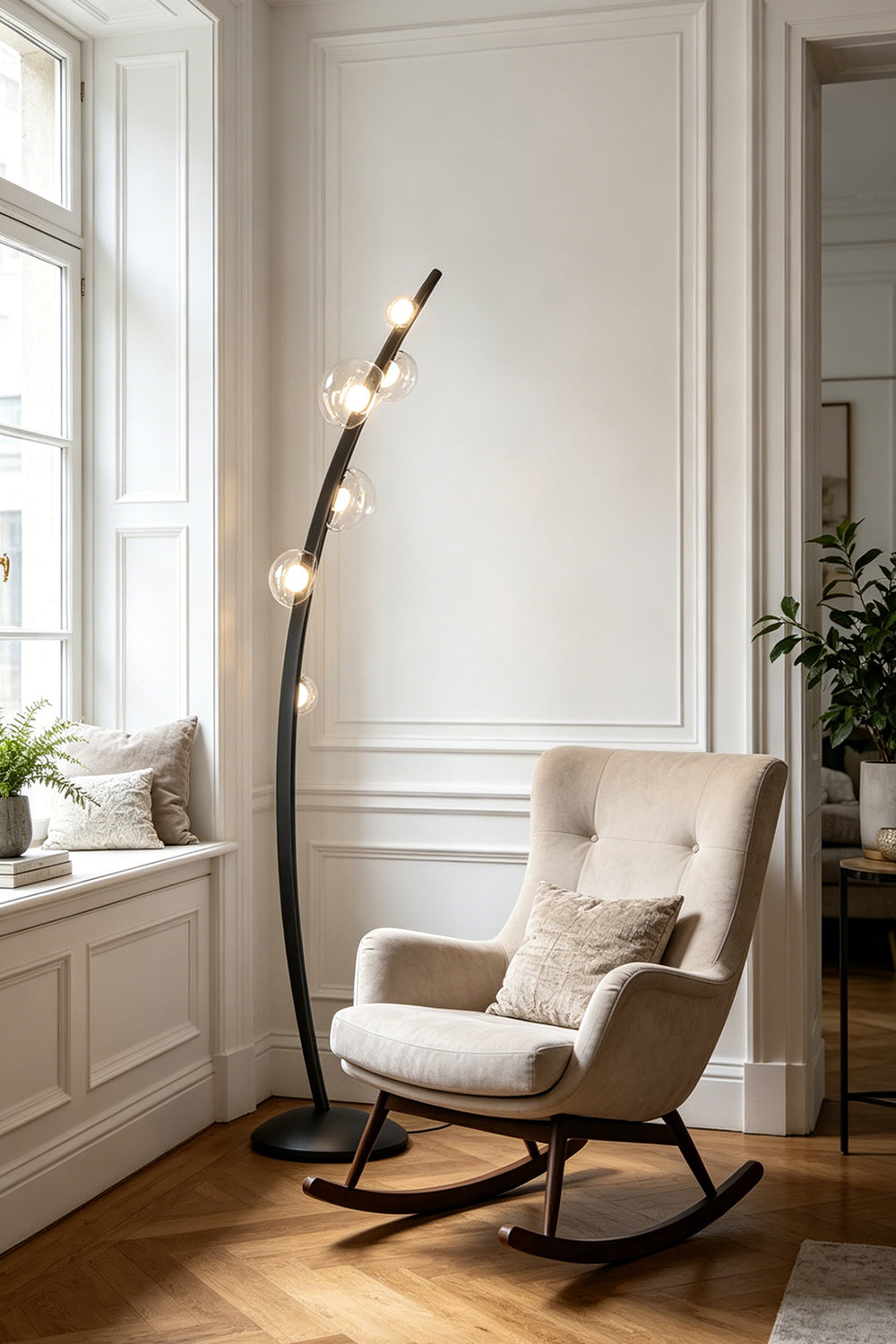 Drosia Dewdrop Floor Lamp | Glass, Metal | Placed next to a tufted beige fabric rocking armchair near a window, providing perfect accent lighting in a serene living room corner | vexa lamps