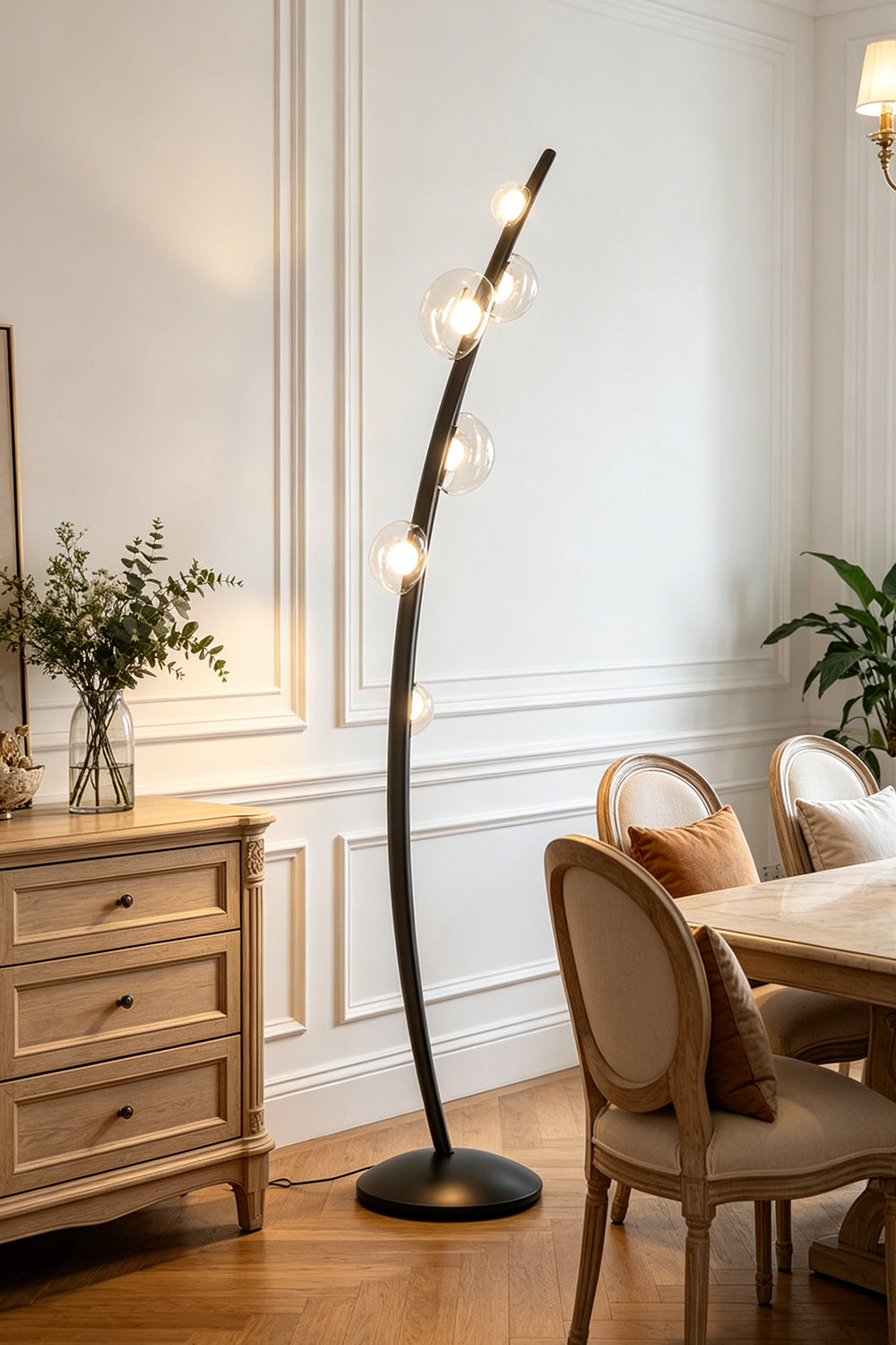 Drosia Dewdrop Floor Lamp | Glass, Metal | Illuminating a classical dining room nook, casting a warm ambient glow next to a wooden console cabinet and dining chair | vexa lamps