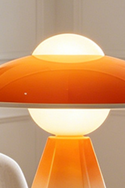 Duskora Retro Mushroom Table Lamp | Ceramic, Glass | Detailed illuminated view highlighting the vibrant translucent orange glossy mushroom dome cap and creamy white diffuser top | Detail shot | vexa lamps