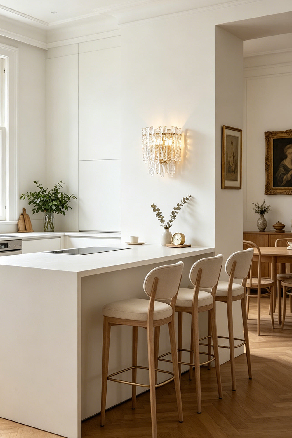 Elara Textured Cast Glass Wall Lamp | Textured Cast Glass, Polished Brass | View across a formal dining room, showing the lamp on a distant wall, balancing the composition with classical architecture and a fireplace | vexa lamps