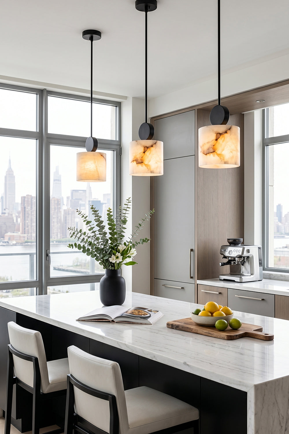 Elian Minimalist Alabaster Pendant Light illuminating a modern kitchen with skyline view and stylish decor.