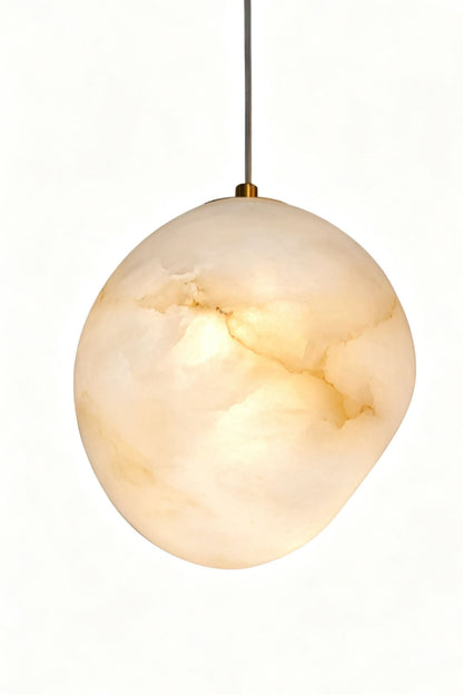 Elodie Teardrop Alabaster Pendant Light showcasing a hand-chiseled organic shape and unique design, perfect for elevating home decor.