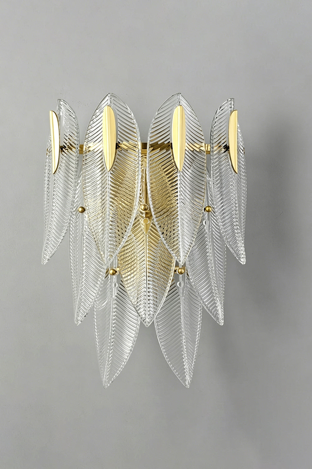 Elowen Cascading Glass Wall Lamp | Glass, Metal | Unlit front studio view of the cascading textured clear glass sconce showcased against a plain grey wall background | vexa lamps