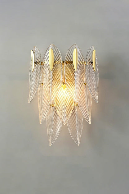 Elowen Cascading Glass Wall Lamp | Glass, Metal | Studio front view of the fully illuminated tiered glass fixture casting a warm, romantic ambient light halo on a grey backdrop | vexa lamps