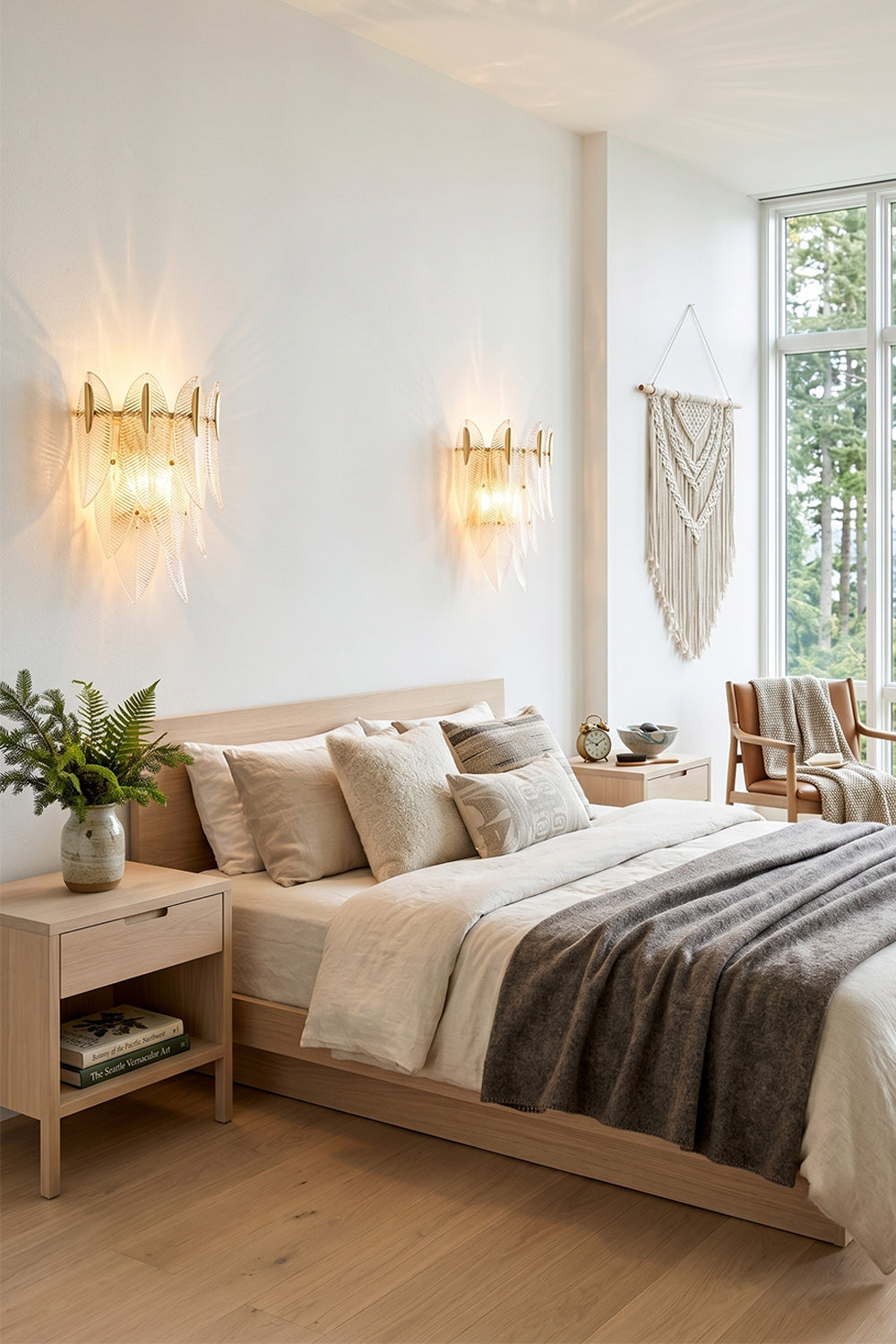 Elowen Cascading Glass Wall Lamp | Glass, Metal | A pair of cascading glass wall sconces symmetrically lighting an elegant contemporary bedroom with neutral linens | vexa lamps