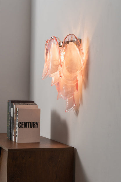 Elysian Bloom Glass Wall Lamp | Metal, Glass | Side angle view of the illuminated pink sconce radiating warm light over a cabinet | vexa lamps