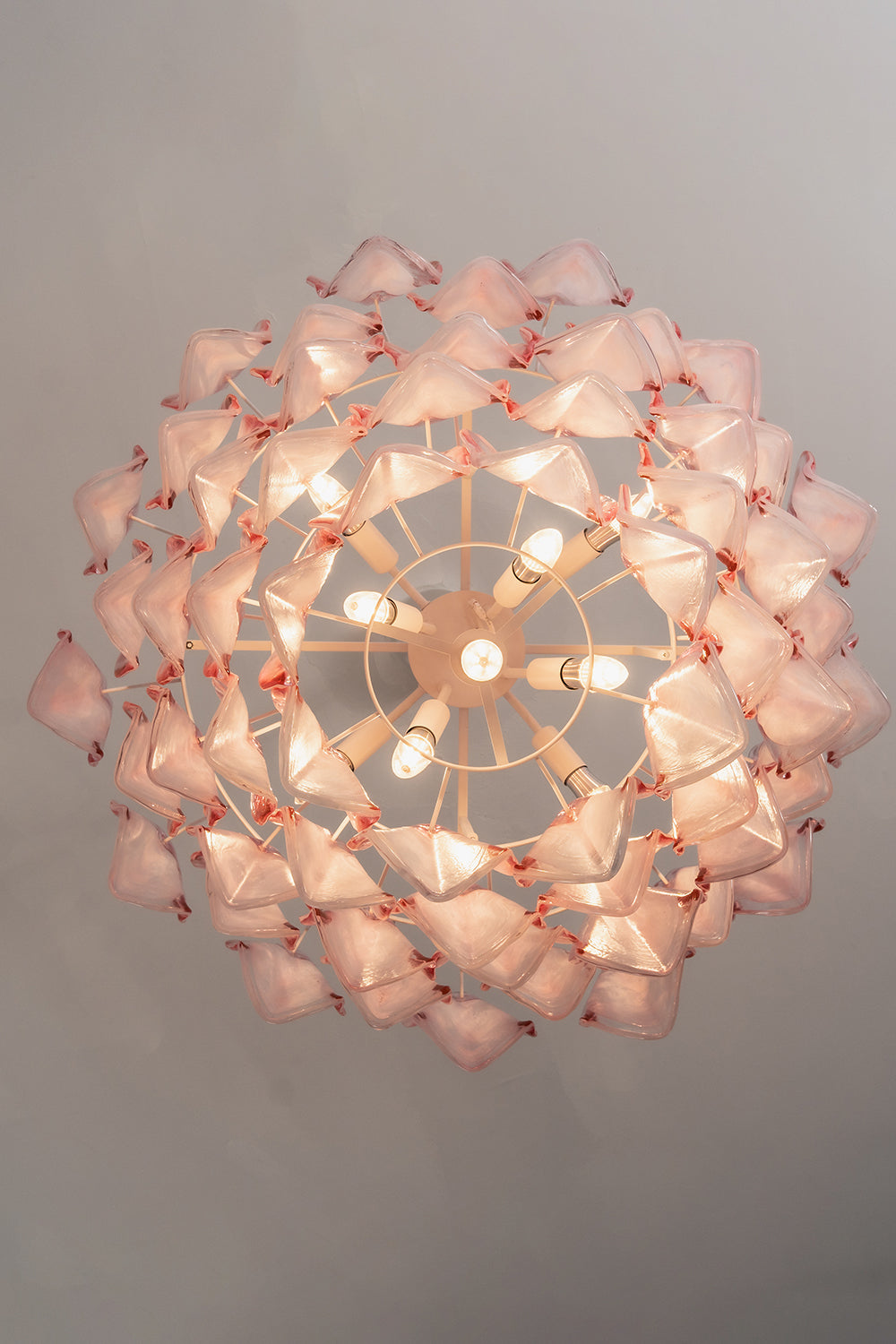 Elysian Bloom Rose Glass Chandelier | Metal, Glass | Directly looking up into the illuminated chandelier, showcasing the radial petal arrangement | Detail shot | vexa lamps