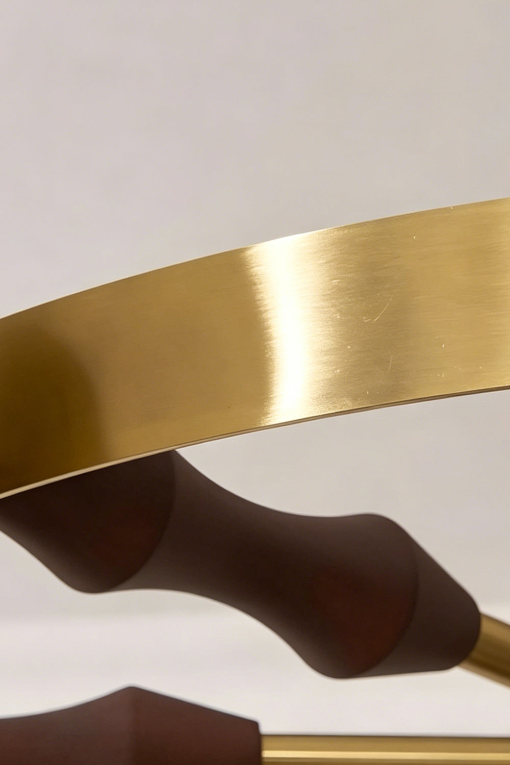 Detailed view of the brass ring and wooden support | Metal, Wood | Showing the warm metallic finish and wood grain | vexa lamps