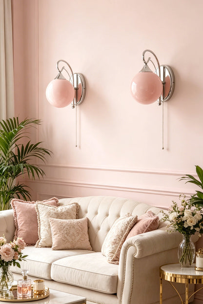 Two pink glass wall lamps | Metal, Glass | Mounted on pink wall above tufted sofa | vexa lamps