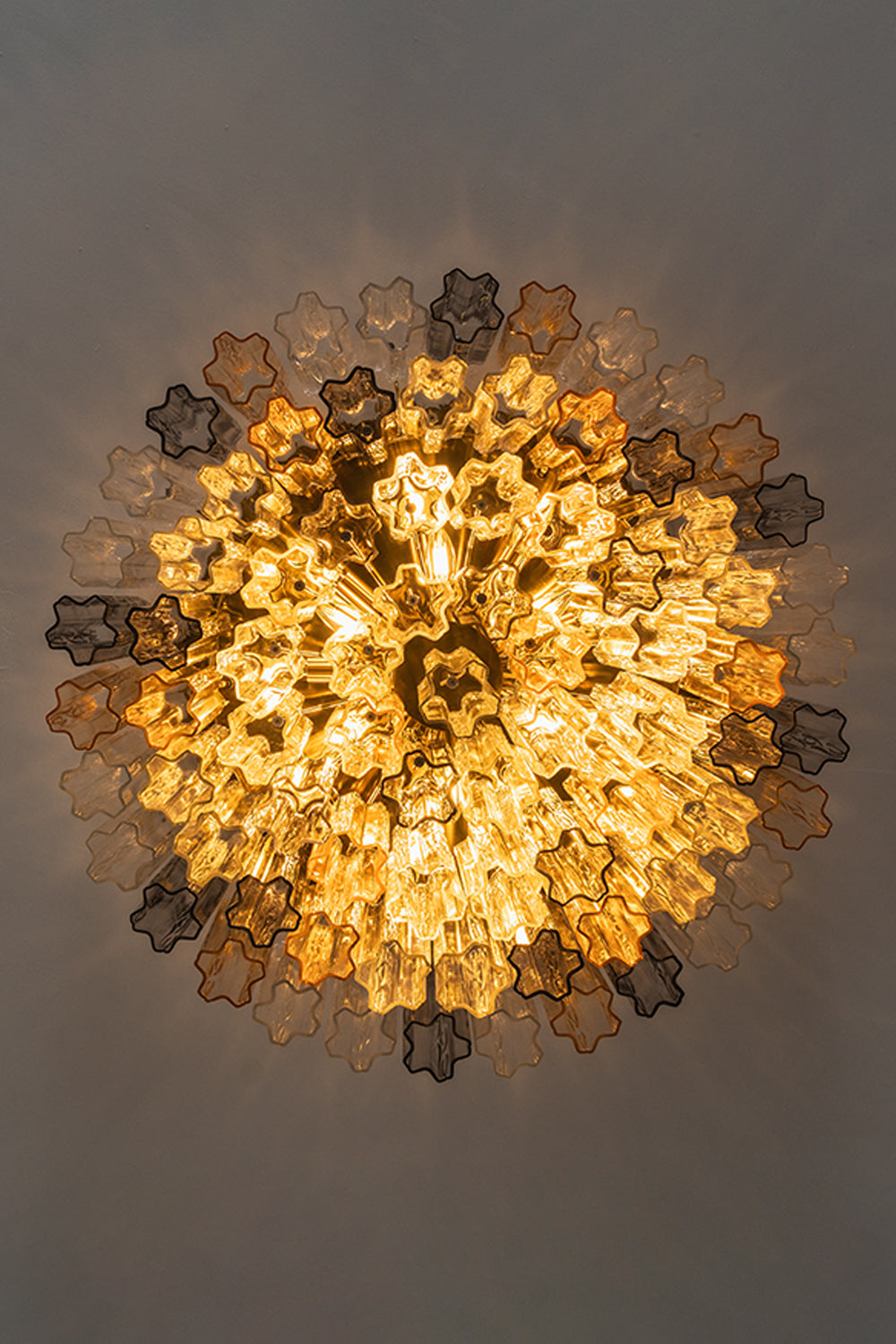 Elysian Tiered Fluted Ceiling Light | Glass, Metal | Direct bottom-up perspective view looking into the glowing radial concentric tiers of fluted glass rods | Detail shot | vexa lamps