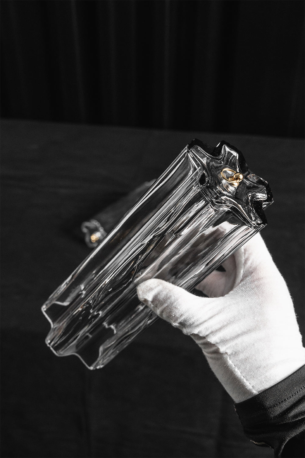 Elysian Tiered Fluted Ceiling Light | Glass, Metal | A gloved hand holding a single molded rectangular wave-shaped clear glass rod component to demonstrate its profile and size | Detail shot | vexa lamps