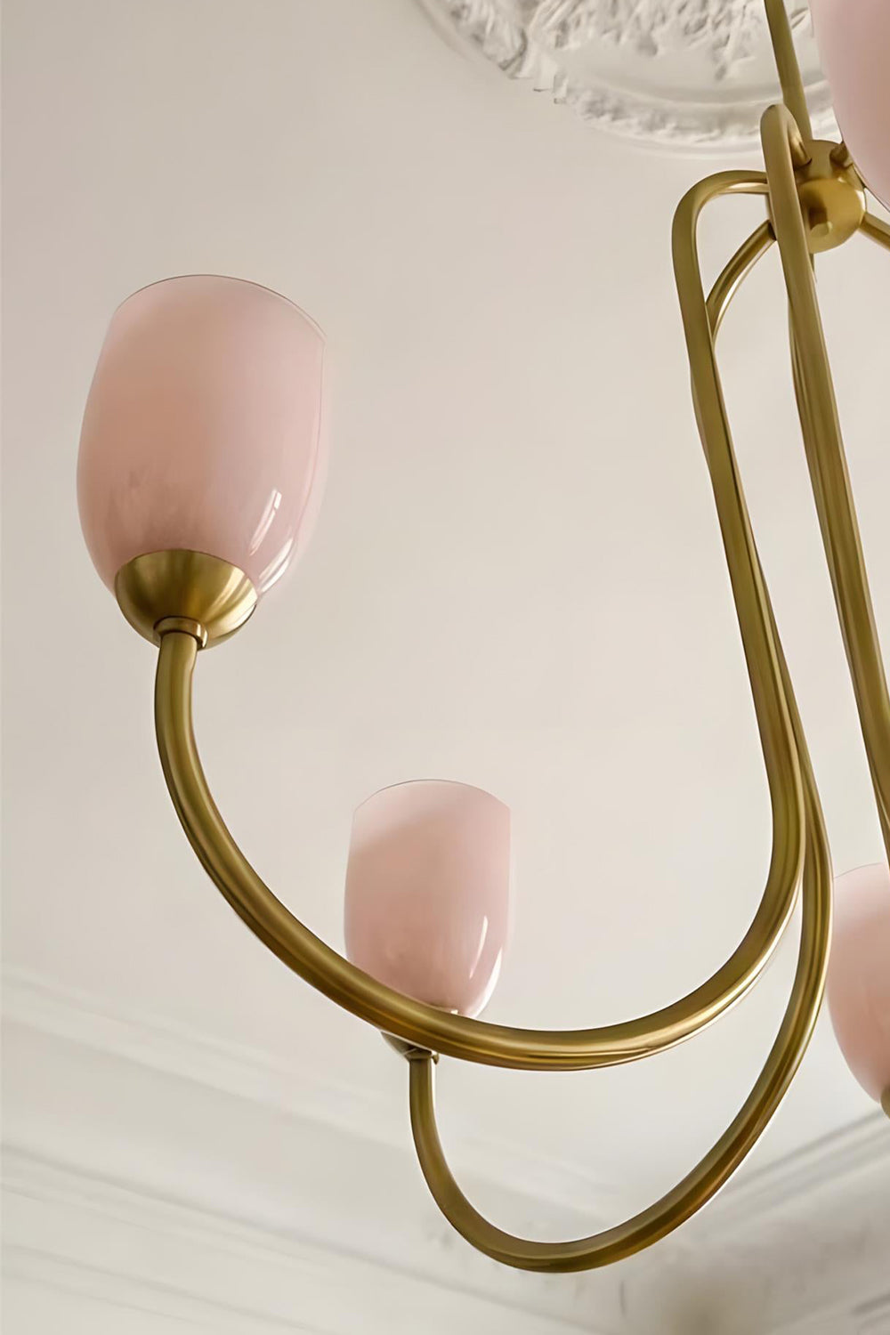 Close-up detail of the intricate brass-finished metal frame of a Ethereal Floret Chandelier | Metal | Functional detail view of the ceiling mount and arms | vexa lamps