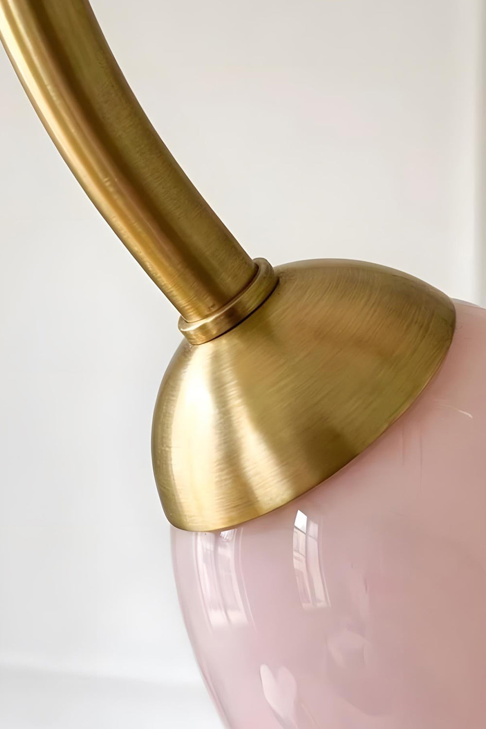 Detail of the brass-finished metal arm joining a pink glass shade base | Metal, Glass | Functional connection point of Ethereal Floret Chandelier | vexa lamps