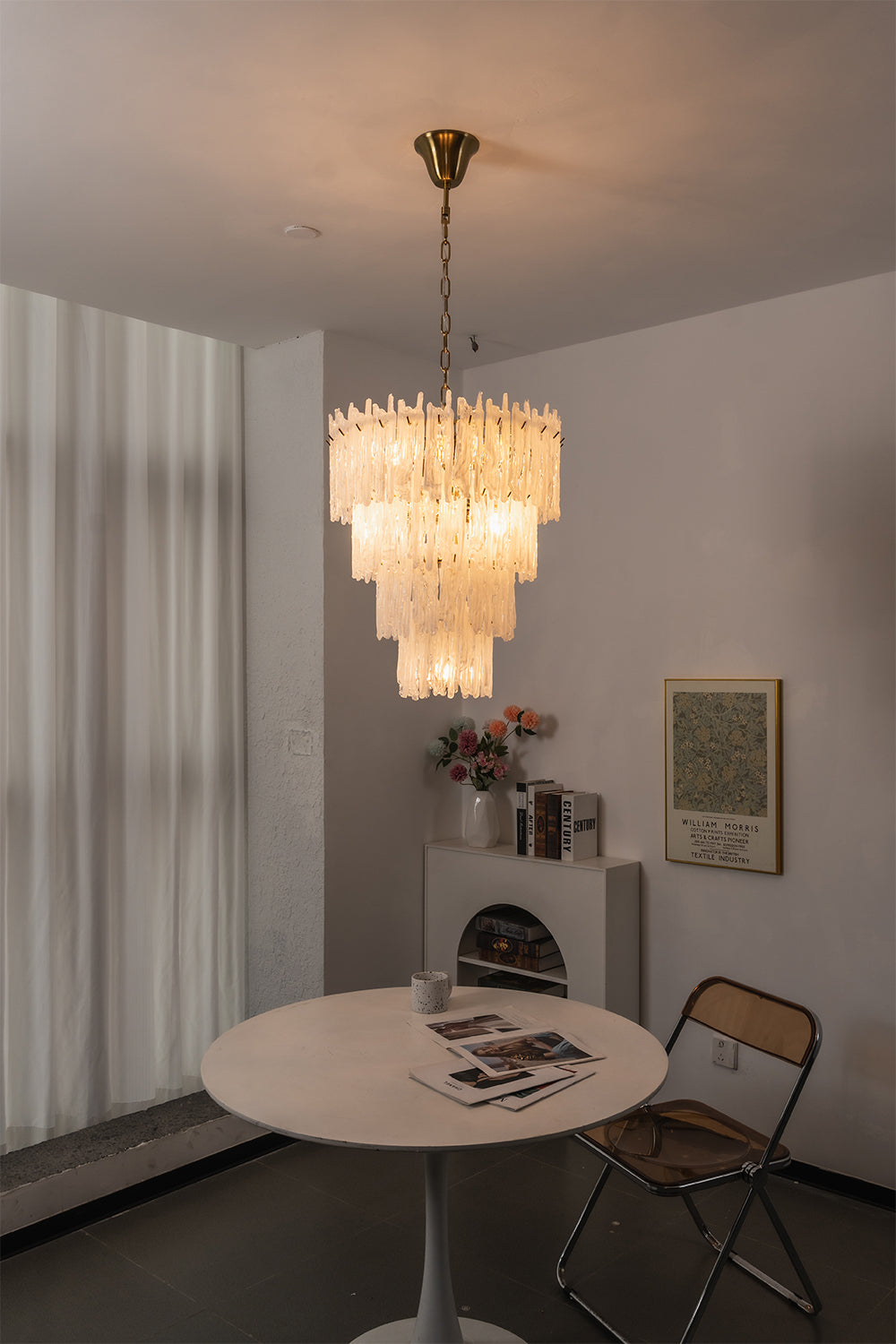 Ethereal Icicle Waterfall Chandelier | Glass, Metal | Mounted over a simple round table in a minimalist dining corner next to white curtains | vexa lamps