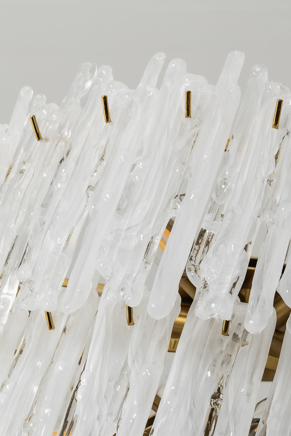 Ethereal Icicle Waterfall Chandelier | Glass, Metal | Close-up focus on the textured, melting-ice appearance of the white frosted glass panels | Detail shot | vexa lamps