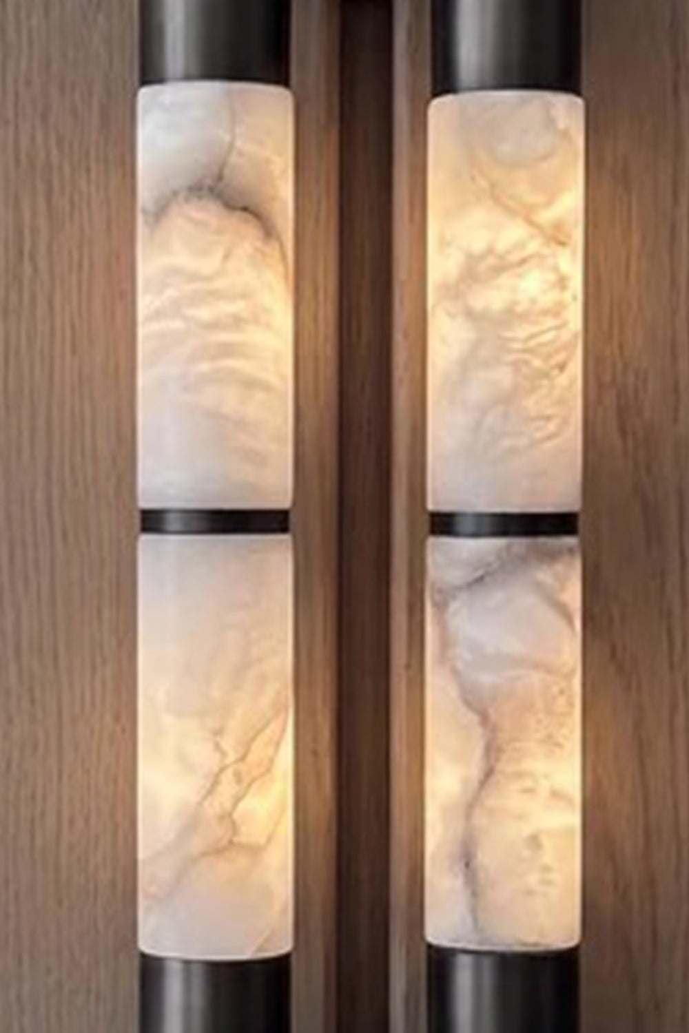 Evadne Alabaster Link Wall Sconce | Alabaster, Metal | Detailed close-up shot highlighting the intense cloudy translucent textures and unique mineral veining of the twin illuminated alabaster rods | Detail shot | vexa lamps