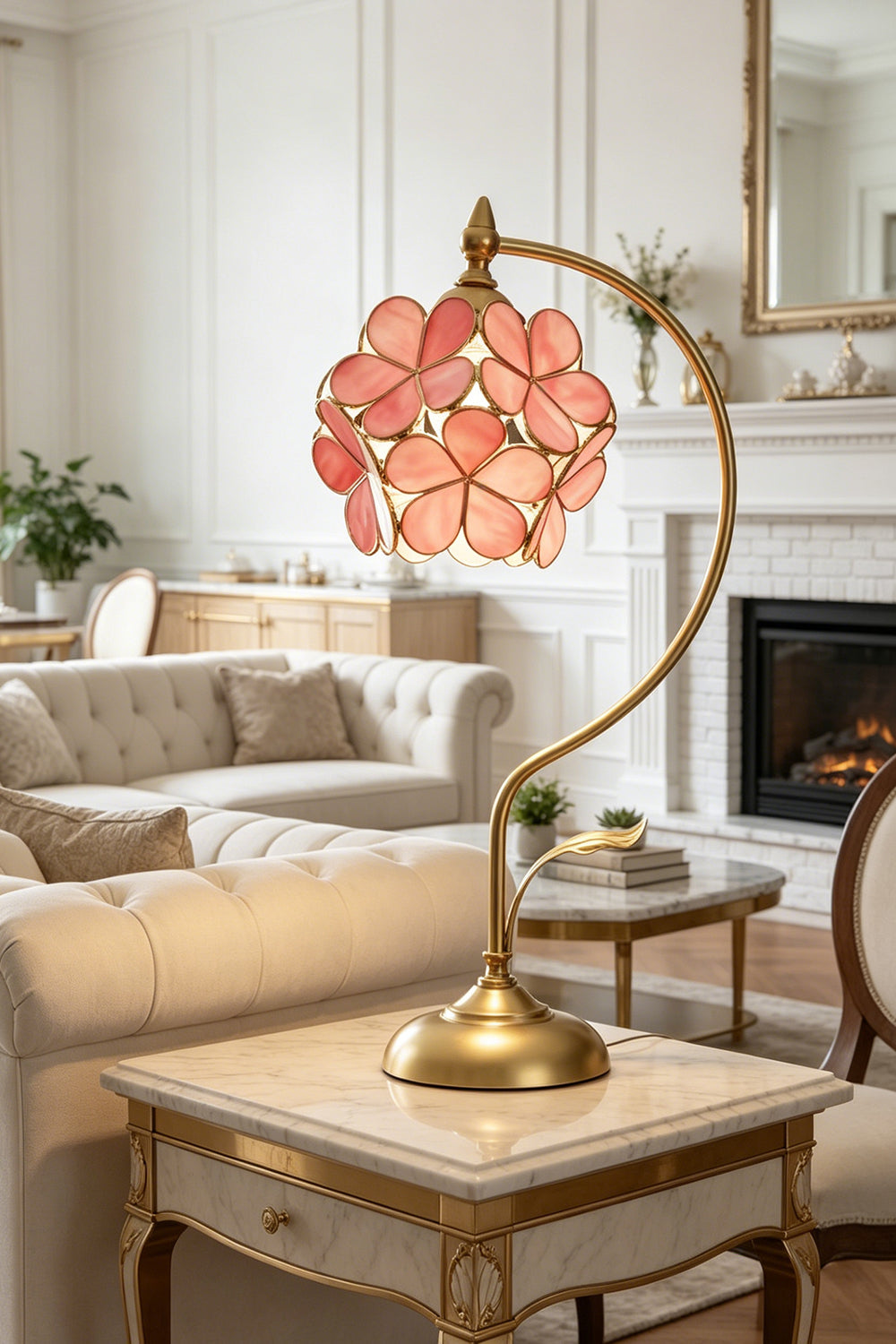 Evanthe Blossom Stained Glass Table Lamp | Stained Glass, Metal | Pink variant glowing softly on an elegant marble-topped side table next to a cream fabric sofa | vexa lamps
