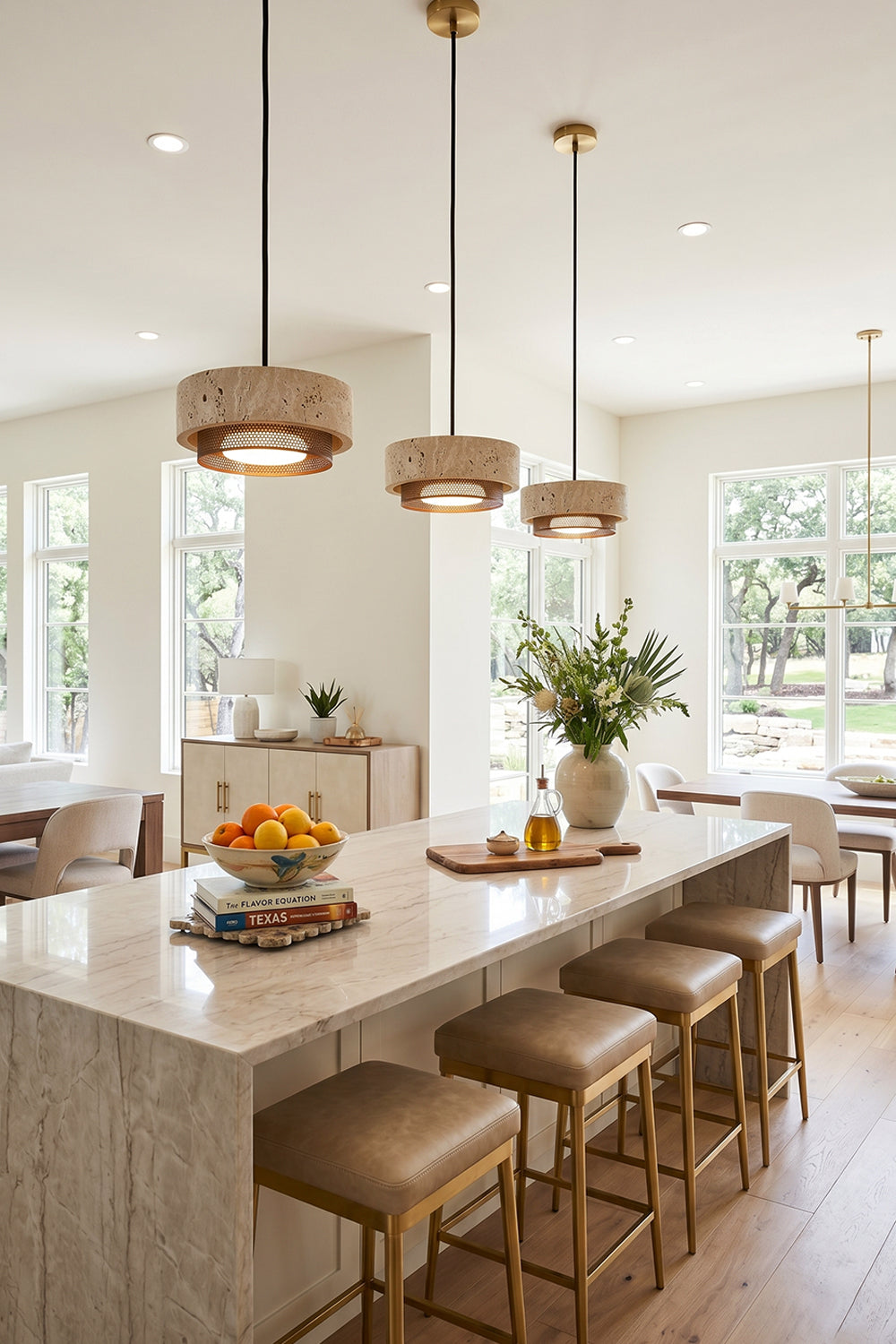 Evora Travertine Pendant Light illuminating a modern kitchen with marble countertop and elegant seating.