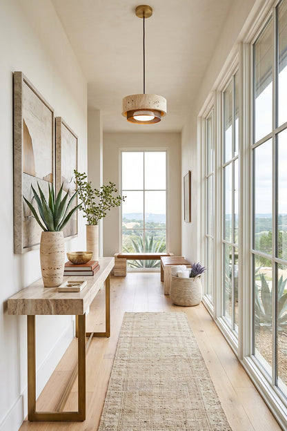 Evora Travertine Pendant Light featured in a modern hallway with natural decor and large windows.
