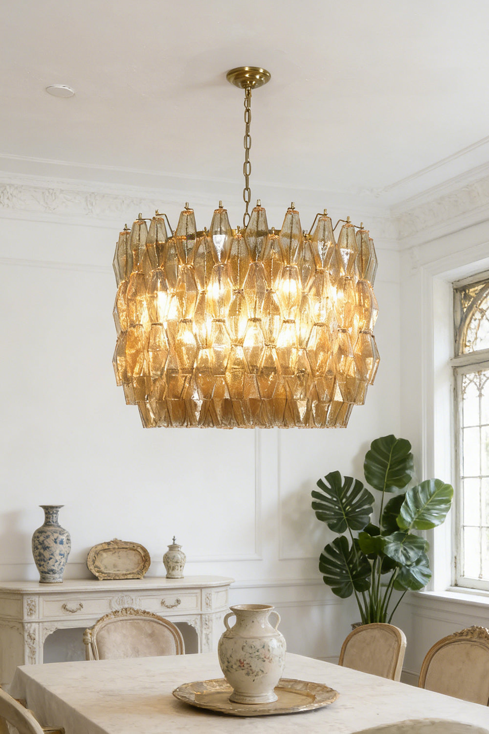 Amber drum Sorrento chandelier over dining table | Metal, Glass | Centered in a traditional dining room with wooden chairs | vexa lamps