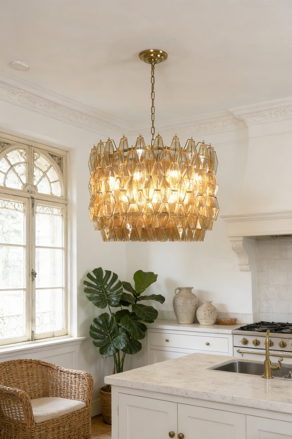 Faceted amber glass drum pendant light | Metal, Glass | Installed in a bright kitchen area with white cabinetry | vexa lamps