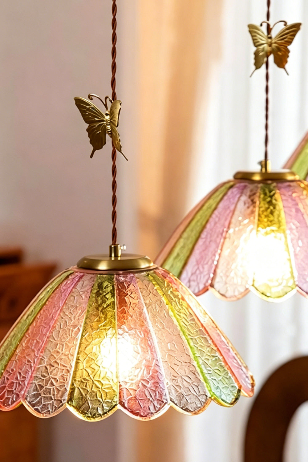 Faye Pastel Scalloped Glass Pendant Lamp | Glass, Metal | Two butterfly glass pendant lights hanging at staggered heights next to soft window curtains | vexa lamps