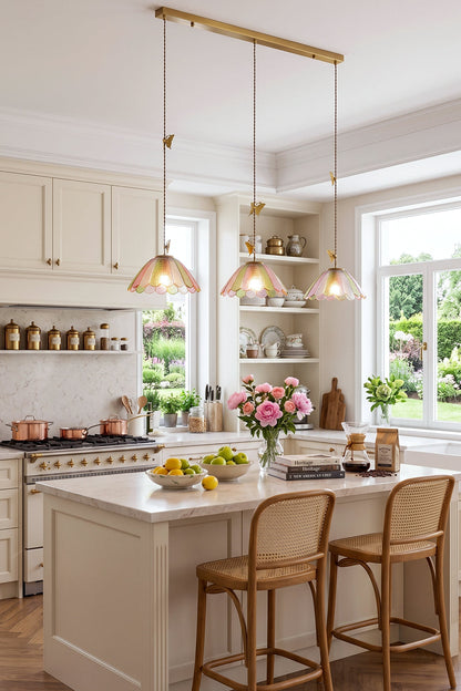 Faye Pastel Scalloped Glass Pendant Lamp | Glass, Metal | Linear 3-light pendant fixture casting a warm ambient glow over a white marble kitchen island with stools | vexa lamps