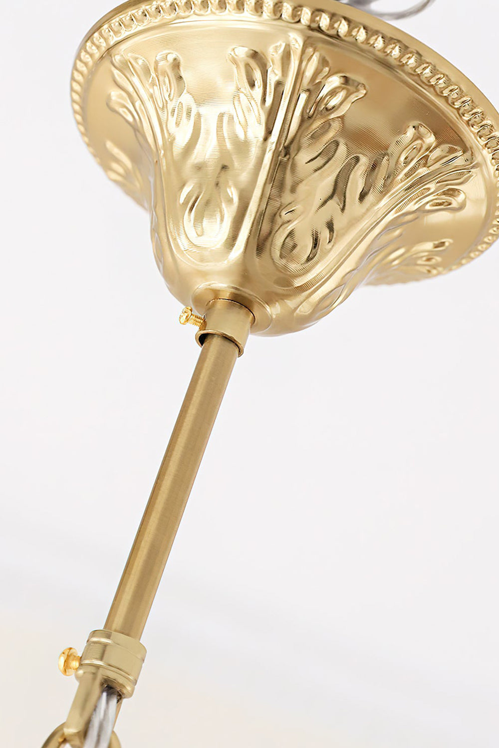 Ceiling mount detail of the Fiore Radiance Glass Disc Chandelier showcasing ornate gold craftsmanship.