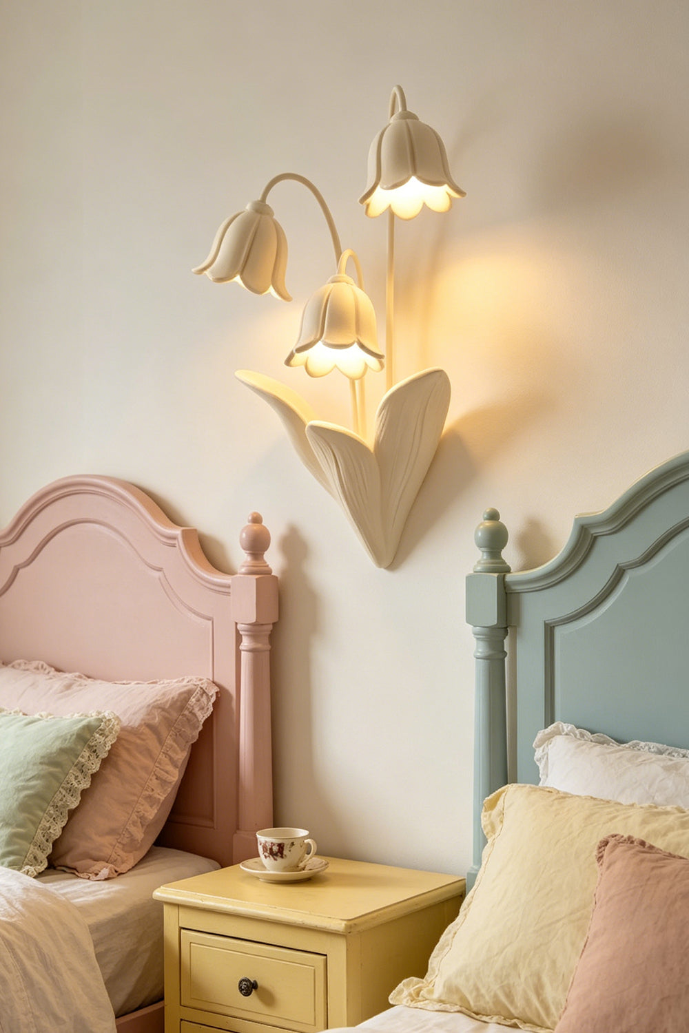 Floral resin wall sconce in a pastel-toned bedroom | Metal, Resin |