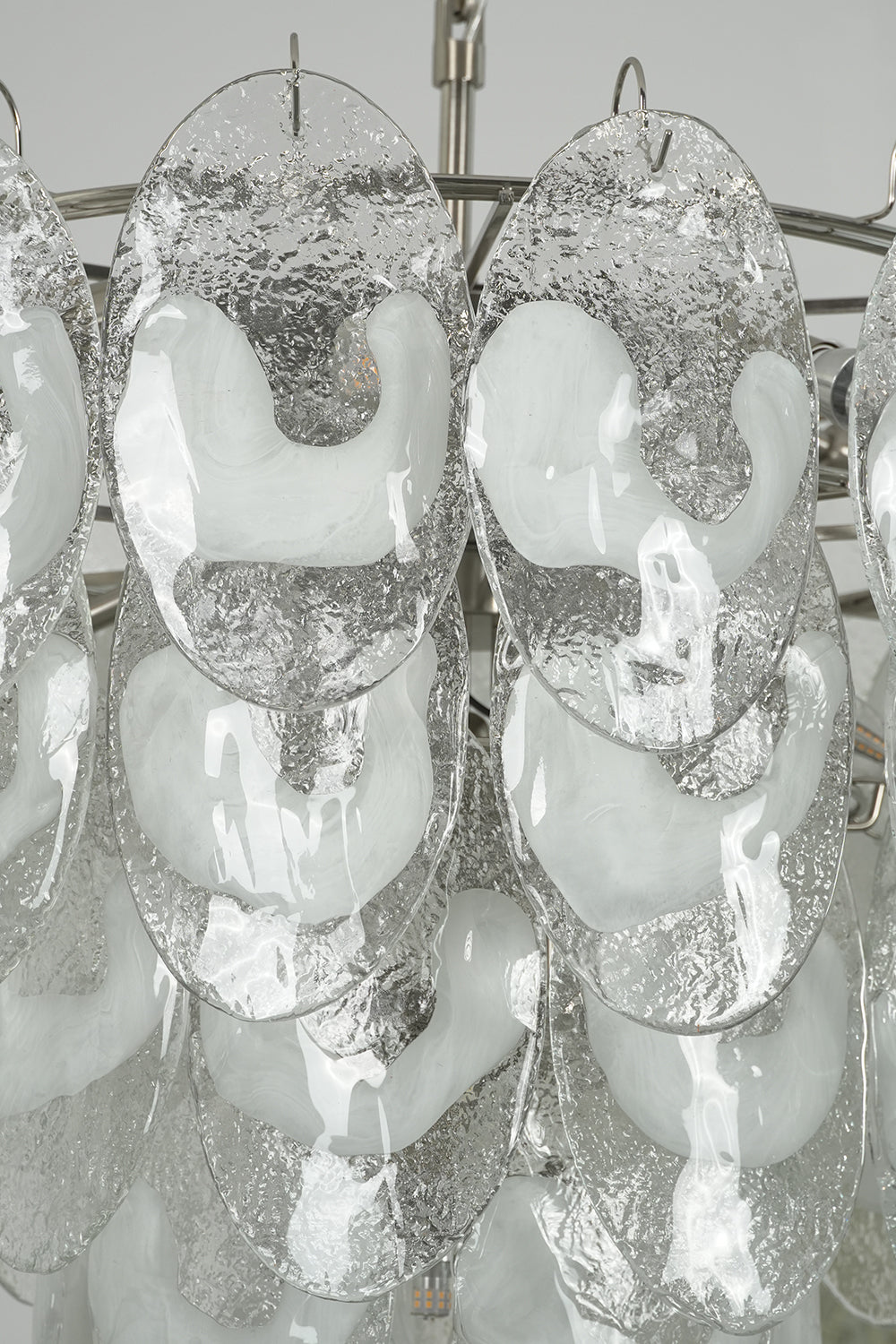 Detailed close-up of unlit cascading glass leaves | Glass | Showing the layering and transparency of Frostelle chandelier | vexa lamps