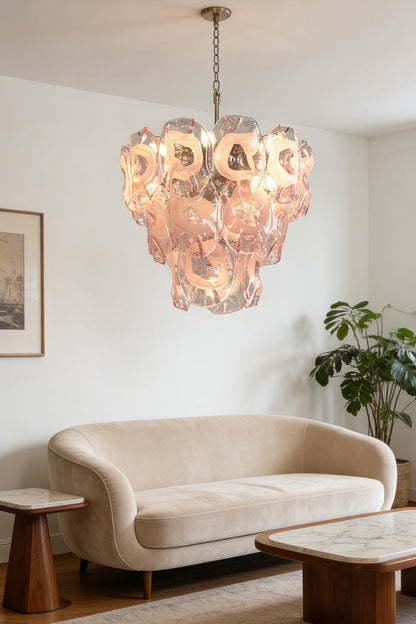 Tiered pink petal chandelier | Metal, Glass | Over a curved sofa in a contemporary living room | vexa lamps