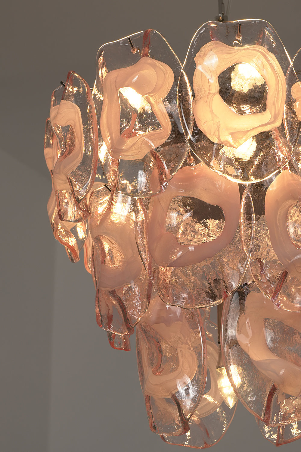 Lit pink glass petals detail | Glass | Close-up showing warm illumination through pink glass | vexa lamps