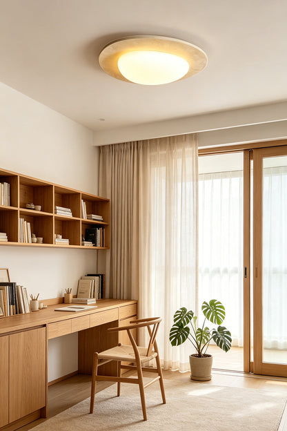 Geoidal Halo Travertine Ceiling Light | Travertine, Glass | Illuminated in a modern home office with wood desk and plants | vexa lamps