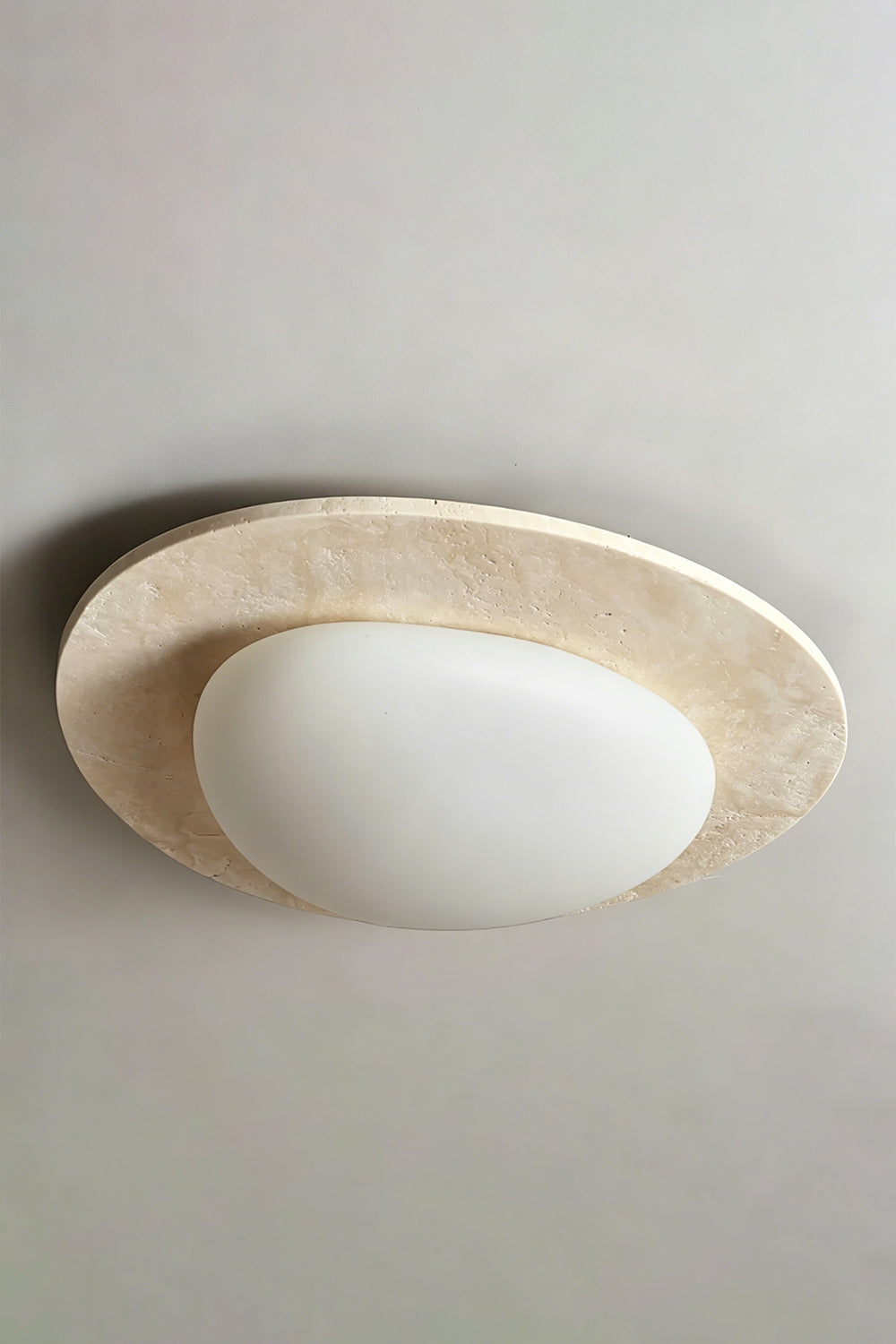 Travertine Ceiling Light Detail | Travertine, Glass | Center oval diffuser view against grey ceiling | Smooth glass focus | vexa lamps