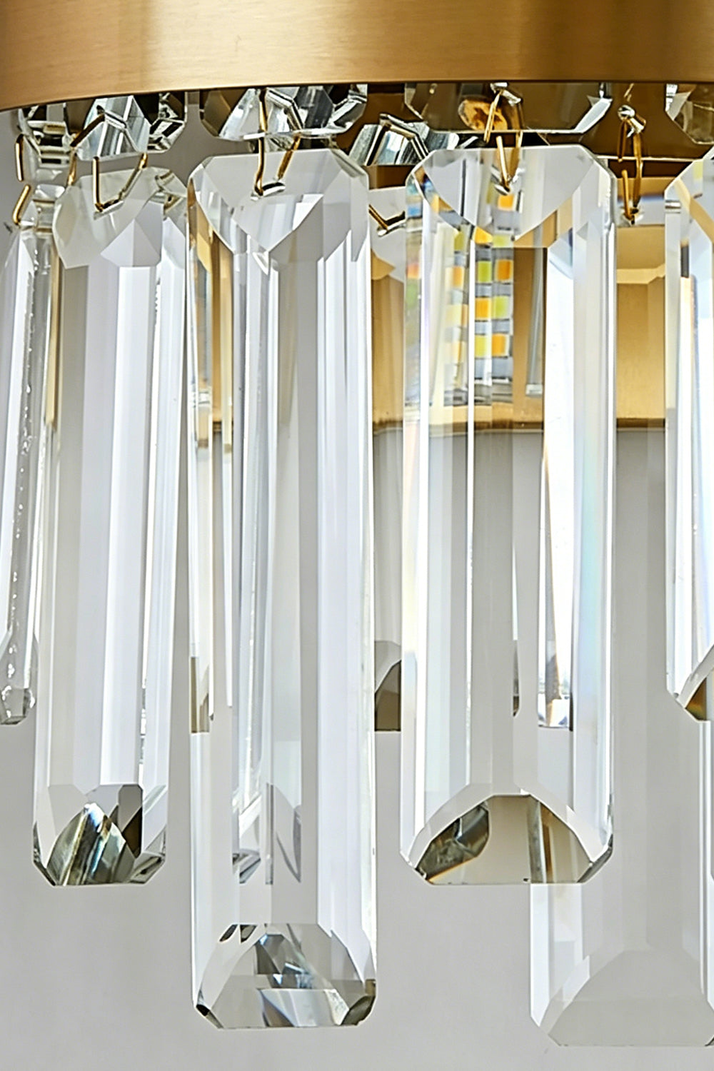 Glacia Tiered Crystal Statement Wall Lamp | Crystal, Metal | Close-up focus highlighting the hollow rounded bottom edge and sparkling facet reflections of the clear tiered crystal glass rods | Detail shot | vexa lamps