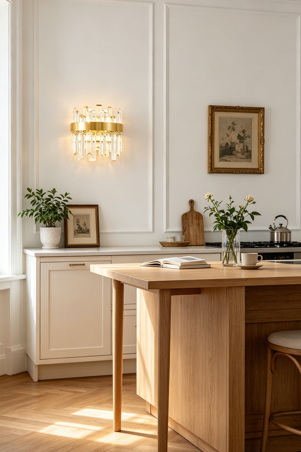 Glacia Tiered Crystal Statement Wall Lamp | Crystal, Metal | Styled beautifully on a white wall above a wooden dining table or console counter in a sunlit open-concept kitchen area | vexa lamps