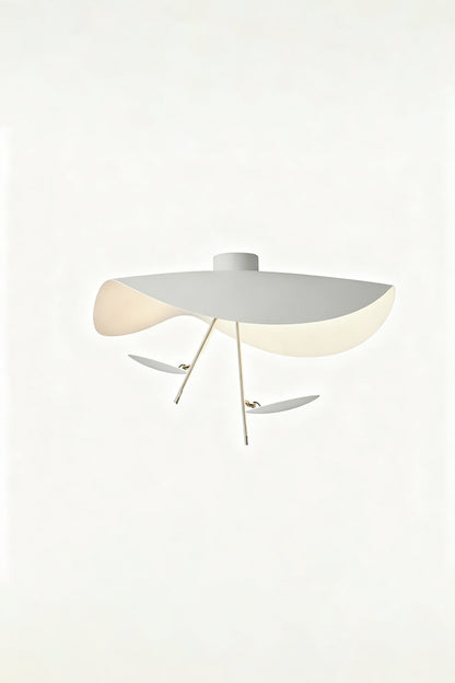 Gold-Tone Sculptural Ceiling Light featuring fluid geometry and a wave-like design, illuminated with a warm glow.