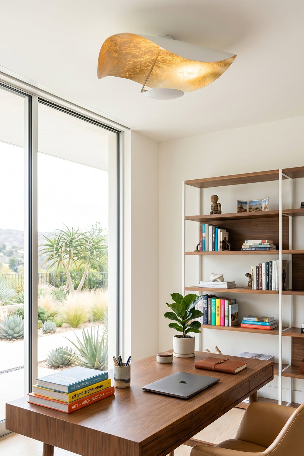 Gold-Tone Sculptural Ceiling Light illuminating a modern office space with a wooden desk and shelves.