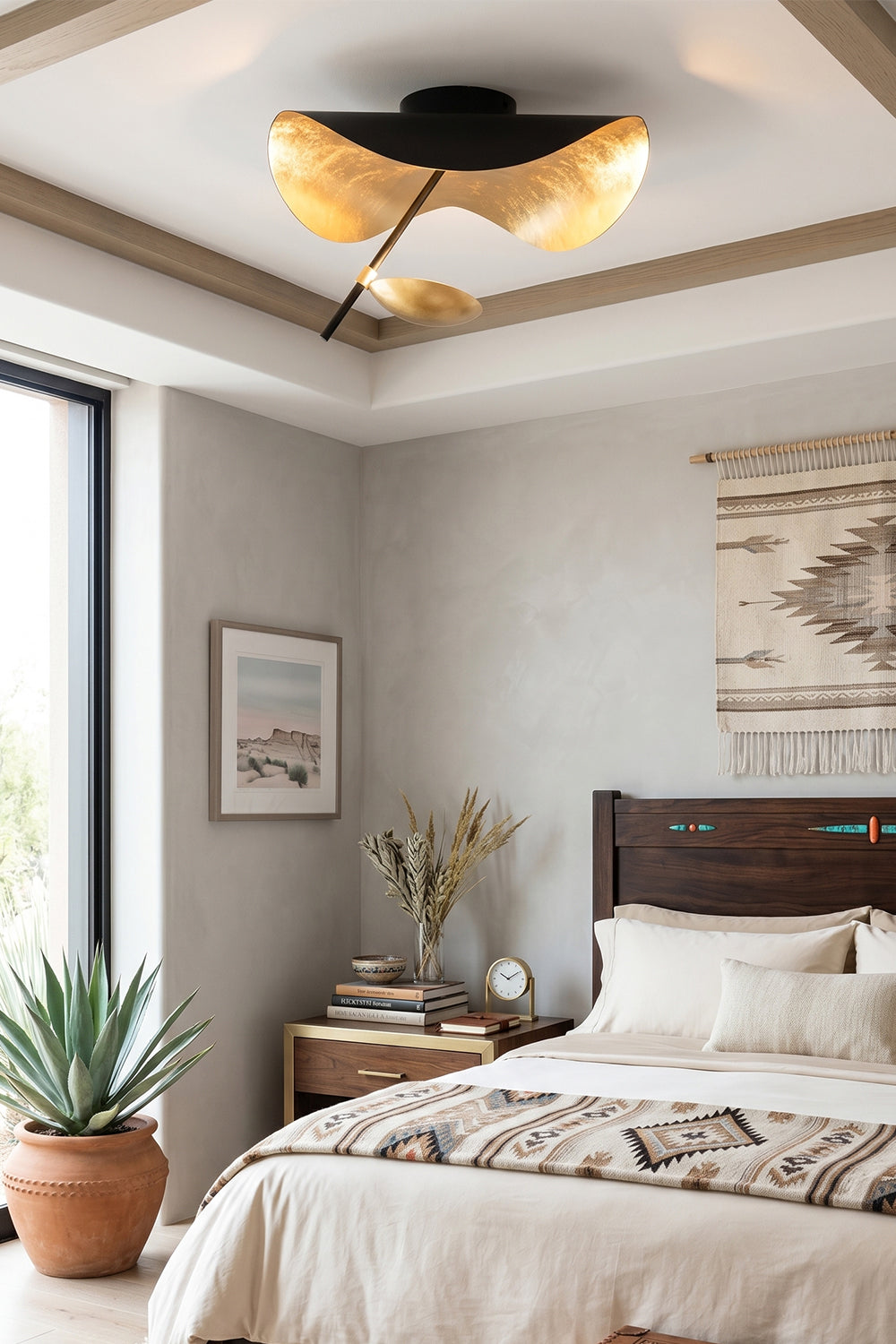 Gold-Tone Sculptural Ceiling Light illuminating a modern bedroom with stylish decor and natural light.