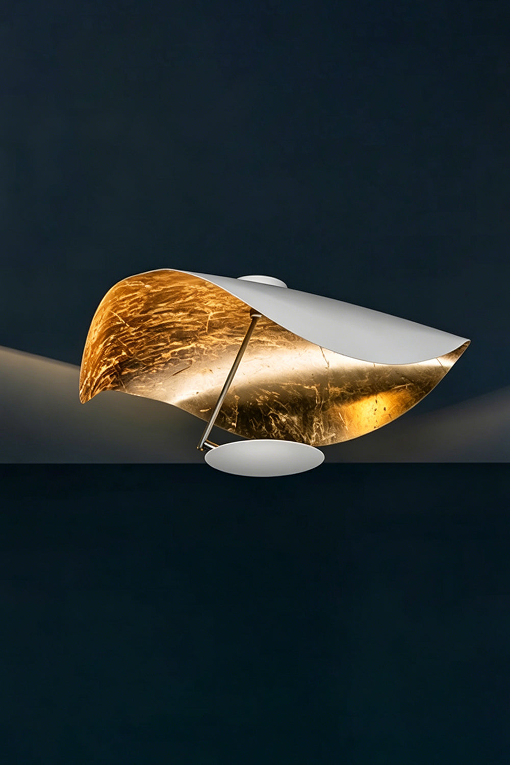 Gold-Tone Sculptural Ceiling Light featuring a wave-like design and textured gold finish on the canopy.
