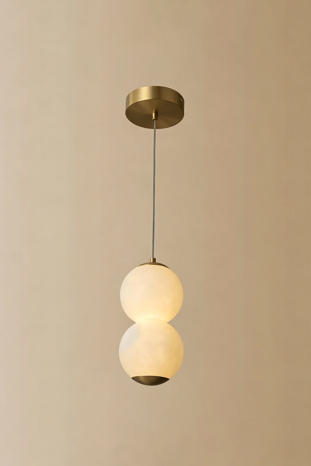 Imperial Epoch Alabaster Pendant Lamp | Metal, Alabaster | Full view of the two-sphere pendant variant against a beige background | vexa lamps
