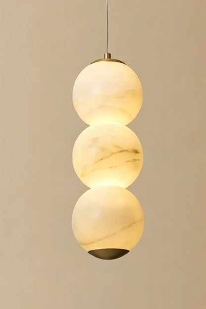 Imperial Epoch Alabaster Pendant Lamp | Metal, Alabaster | Close-up of three stacked stone spheres against a warm neutral background | vexa lamps