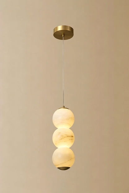 Imperial Epoch Alabaster Pendant Lamp | Metal, Alabaster | Full view of the three-sphere pendant variant against a beige background | vexa lamps
