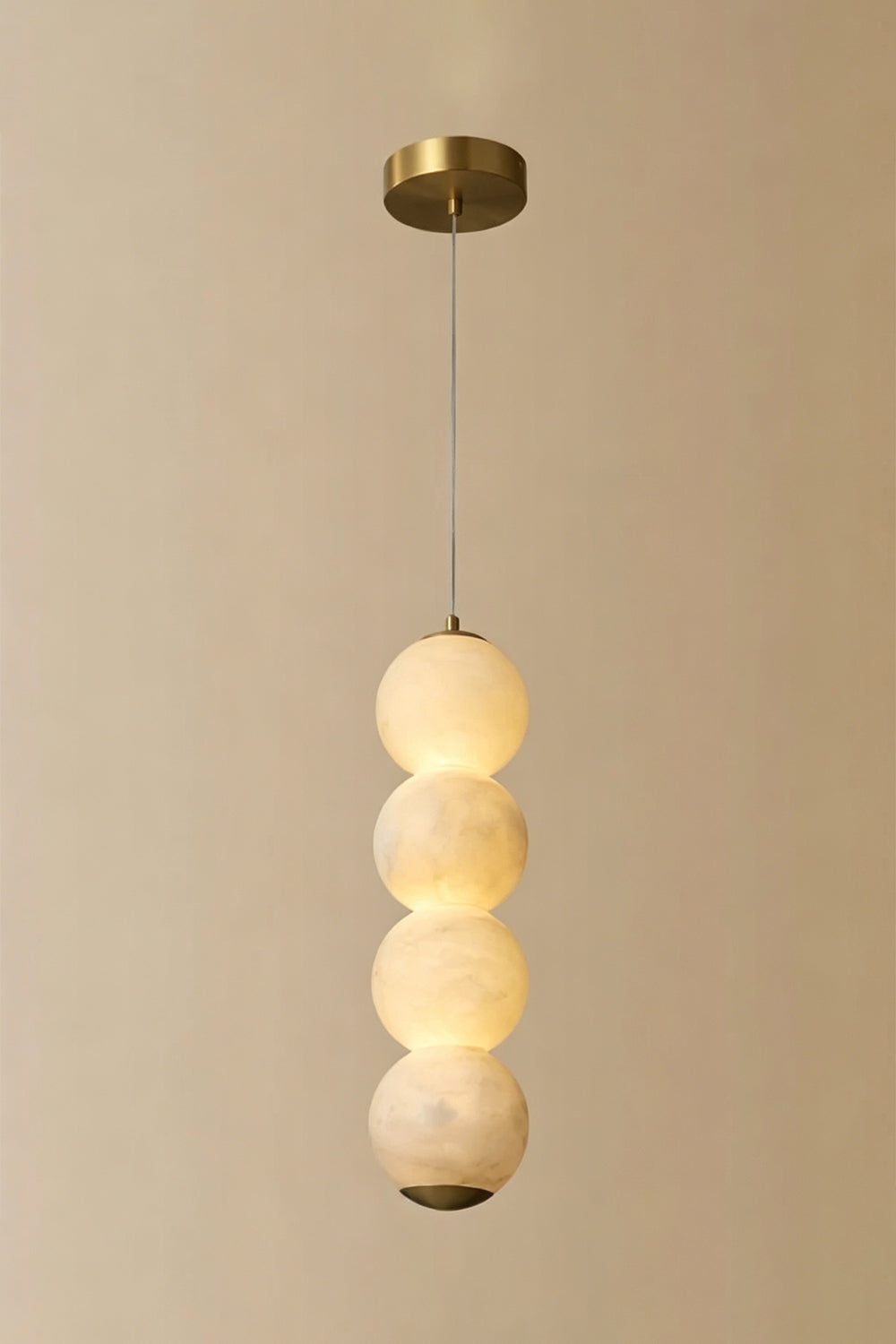 Imperial Epoch Alabaster Pendant Lamp | Metal, Alabaster | Full view of the four-sphere pendant variant against a beige background | vexa lamps