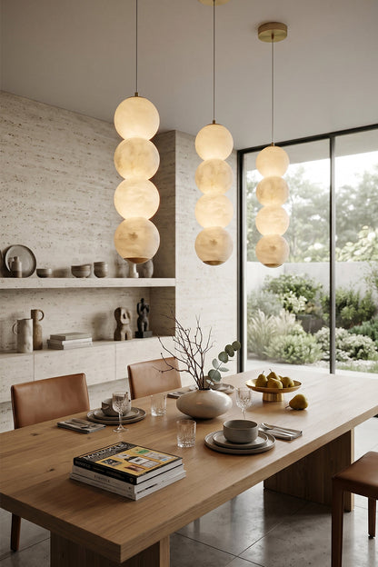 Imperial Epoch Alabaster Pendant Lamp | Metal, Alabaster | Three alabaster lamps hanging over a wooden dining table in a contemporary home | vexa lamps