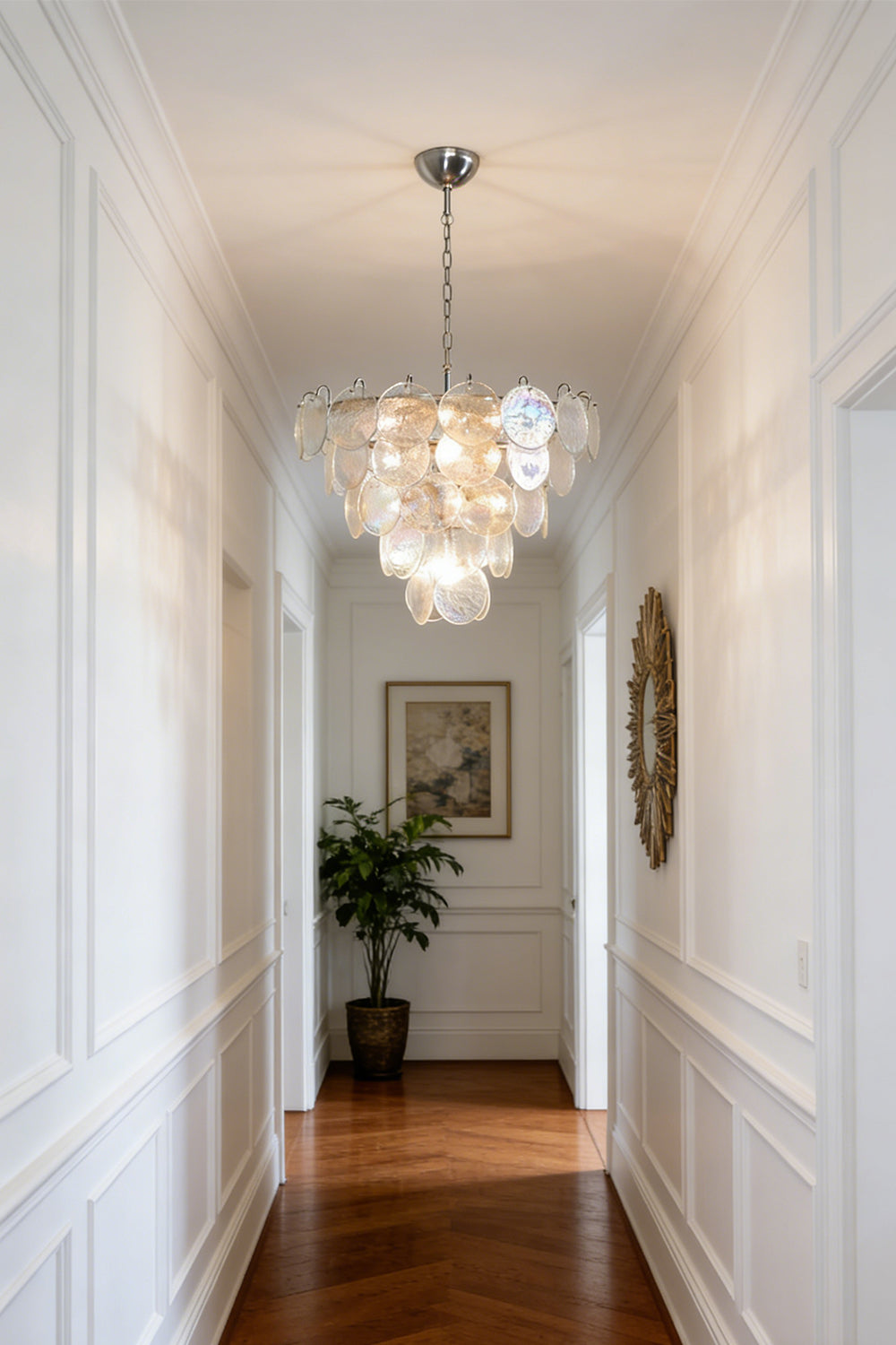 Cascading glass disc chandelier | Metal, Glass | Installed in a high-ceiling hallway corridor | vexa lamps