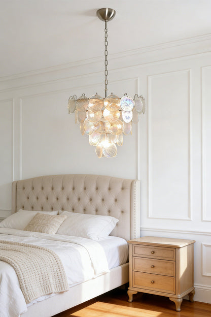Serene iridescent glass chandelier | Metal, Glass | Mounted in a master bedroom above a tufted bed | vexa lamps